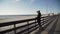 Woman on the wooden stairs in the dunes beach on the sea in hat enjoying life and leisure, everyday successful women