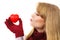 Woman in woolen gloves holding red heart and sending kiss, symbol of love
