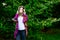 Woman in woolen sweater listening to music in park