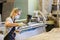 A woman in a work uniform working at the factory or workshop. The concept of women`s equality and feminism. Female carpenter