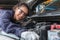 Woman worker at automobile service center, Female in auto mechanic work in garage car technician service check and repair customer