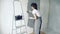 Woman worker using a spatula applying decorative plaster in the apartment or house. Construction, repair and renovation