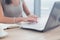 Woman working as copywriter at home. Close-up picture of female hands on pc keyboard in light office.