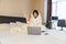 woman working in bed on laptop covered with blanket