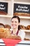 Woman working behind a counter in a bakery