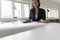 Woman working on a blue manual calculator in an office