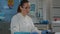 Woman working in chemistry laboratory with computer