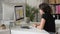 Woman working closely in front of monitor in office. Schedule of planning.