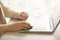 Woman working on computer close up. Woman hands typing on keyboard of laptop, online shopping detail. Business, remote