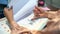 Woman working document, Person seated at a table with a cup of hot coffee reading a paper document