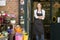 Woman working at flower shop smiling