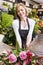 Woman working at flower shop smiling