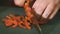 Woman working in the kitchen chopping up the vegetables. Female slicing pepper for salad.