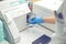 Woman working in a laboratory on a modern machine for blood testing. Doctor checks the blood of the patients.