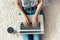 Woman working on a laptop. Female using a laptop sitting on floor, searching web, browsing information, having workplace at home.