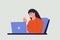 Woman working with a laptop in her cozy workplace. She waves her hand towards the screen. Joyful delightful workday.