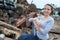 Woman working next to rusted metal scrap pile