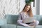 Woman working on notebook at home in cozy atmosphere.