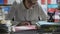 Woman working in the office and piles of paperwork