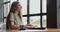 Woman working online and drinking coffee in a cafe.Girl typing on laptop and shutting down computer