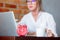 Woman on working place holding a cup of hot drink