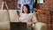 Woman working remotely while in digital videoconference on smartphone