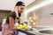 Woman working with silicone glue. Caulking the kitchen