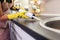 Woman working with silicone glue. Caulking the kitchen