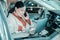 Woman working sitting on a driver seat of her car.