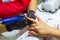 Woman working with a small drill on nails in beauty salon