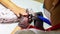 Woman working with a small drill on nails in beauty salon