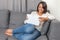 Woman working with tablet sitting on sofa