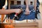 Woman working in upholstery workshop with pneumatic stapler.