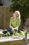 Woman working on vegetable garden in backyard