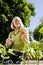 Woman working on vegetable garden in backyard