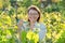 Woman working with vine bushes, spring summer pruning vineyard