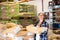 Woman working in warehouse, carrying bag full of corn seeds