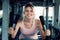 Woman workout cycling exercise in fitness gym., Portrait of pretty attractive caucasian woman cycling training in gym., Beautiful