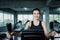 Woman workout elliptical trainer exercise in fitness gym., Portrait of pretty attractive caucasian woman doing elliptical trainer