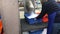 Woman works pouring ice into boxes for storing seafood