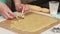 Woman works with snowflake cookie dough. Cooking marshmallow sandwiches. Close-up shot