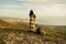 Woman wrapped in plaid standing on peak of mountain