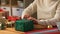 Woman wrapping christmas gift into paper at home