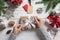 Woman wrapping Christmas gift at wooden table