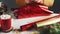 Woman wrapping Christmas handmade present in red paper