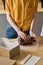 Woman wrapping glass jar in packet