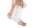 Woman is wrapping her leg with sprained ankle with elastic bandage  on white background. Twisted bandaged ankle with bruis