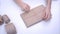 Woman wrapping present with jute