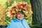 A woman with a wreath of yellow maple leaves on her head