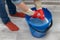 woman wringing out a wet rag in a bucket